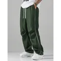 Stylish men's dark green high street techwear joggers with white side stripes and baggy fit - S / Bottoms / Dark Green