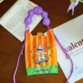 Detail of the cartoon bunny skateboarding and 'go for it!' text on the crossbody bag. - Skateboard Rabbit / Orange