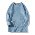 Close-up view of a light blue plush oversized sweatshirt with functional front pockets. - XS / Tops / Light Blue