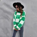 Outdoor style view of a green and white checkerboard drop-shoulder knit sweater for women - S / Tops / Green
