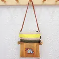 Orange and khaki camping style crossbody bag with a 'Nice day' cartoon patch for keys - Beige And Yellow