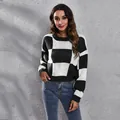 Detailed view of the black and white checkerboard pattern on a short loose knit sweater - S / Tops / Black