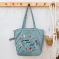 Mint green embroidered tote bag featuring cute cat patterns and a drawstring closure - Hazy Blue Cat and Fish