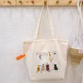 Minimalist cream canvas tote bag with cute cat embroidery and drawstring closure for women - Beige Fishing Cat