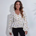Detailed view of women's floral V-neck chiffon blouse with elegant lantern sleeves - S / Tops / White Yellow Floral