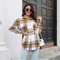 Close-up view of women's mid-length plaid shirt jacket with buttons and large pockets - S / Tops / Khaki