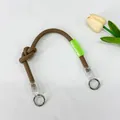 Adjustable brown nylon woven shoulder strap for bags featuring a knot detail and label - Short Hand-Knotted Rope / Khaki