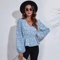 Detail showing the floral print and V-neckline of this elegant blue lantern sleeve blouse - Blue Small Floral