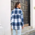 Back view of a blue and white plaid wool blend long sleeve shirt jacket for women. - Blue