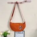 Orange embroidered dumpling crossbody bag with adjustable strap for women - Orange