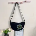 Stylish black nylon crossbody bag featuring detailed colorful floral embroidery pattern - Black