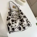 Detailed view of a black floral print canvas tote bag on a white minimalist background - Black Peony
