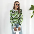 Detailed view of women's loose jacquard knit sweater with green wavy pattern - S / Tops / Green