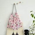 Close-up of a large capacity floral canvas tote bag in a lifestyle setting - Pink Snow Cherry