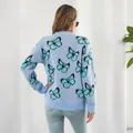 Vista posterior detallada de un suéter de punto azul claro Y2K con patrón de mariposa - S / Tops / Azul Claro con Mariposa Turquesa