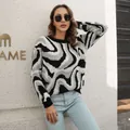 Detailed shot of woman in black and white swirl jacquard knit sweater outdoors - S / Tops / Black