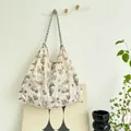 Large capacity canvas tote bag with artistic brown butterfly print hanging in a room. - Butterfly