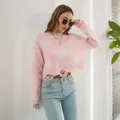 Detailed view of pink Y2K distressed sweater featuring butterfly motifs and frayed hems. - S / Tops / Pink