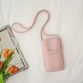 Elegant pink soft leather crossbody phone bag featuring a stylish scalloped pocket detail - Pink