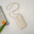 Elegant cream-colored soft leather mini crossbody phone bag with scalloped pocket detail. - Beige