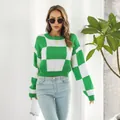 Detail view of a stylish green and white checkerboard knit sweater worn by a model - S / Tops / Green