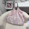Fresh white handbag with pink floral embroidery and brown woven handle on white chair - M / Pink Fireworks