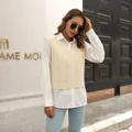 Sleeveless cream cable-knit sweater vest styled over a white shirt in an urban setting - S / Tops / Light Blue