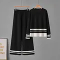 Elegante conjunto de punto negro de dos piezas con rayas blancas en el jersey y pantalón - Talla única / Top y Pantalones / Negro