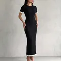 Elegant black ribbed knit maxi dress with white ruffled hem and cuffs. - S / Dresses / Black