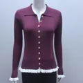 Front detail of a slim-fit plum ribbed knit cardigan with ruffle hem and gold buttons - S / Tops / Burgundy
