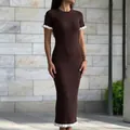 Full view of brown ribbed knit maxi dress featuring contrast white ruffle hem and sleeves. - S / Dresses / Brown