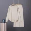 Detailed view of cream minimalist two-piece knit sweater and skirt set on hangers - One Size / Top And Bottom / Apricot