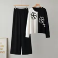 Detail view of a black and white color-block knitted sweater and wide-leg pants two-piece set - One Size / Top And Bottom / Black