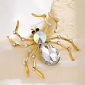 Detailed view of a gold-toned spider brooch featuring large teardrop and iridescent crystals. - White Crystal Spider Brooch