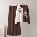 Detail of color-block knit sweater and brown wide-leg pants set with floral patterns. - One Size / Top And Bottom / Brown