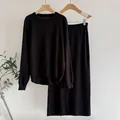 Elegant black two-piece knit set featuring a long-sleeve sweater and matching midi skirt - One Size / Top And Bottom / Black