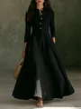 Detail of a vintage black linen maxi dress with mandarin collar and gold buttons. - Black
