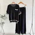 Chic women's two-piece knit lounge set with black and white contrast trim details. - Top And Bottom / One Size / Black