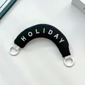 Black minimalist padded curved bag handle featuring white HOLIDAY embroidery design - Handbag Style / Black Handheld