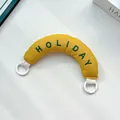 Cute yellow stuffed bag handle accessory featuring green embroidered Holiday text - Handbag Style / Ginger Yellow