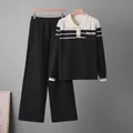 Close-up detail of a chic two-piece striped polo knit sweater and wide-leg pants set - One Size / Top And Bottom (6635) / Black