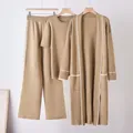 Detail view of women's khaki knitted three-piece lounge set with contrast white trim. - One Size / Set / Camel