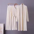 Detail view of a cream three-piece ribbed knit set featuring a cardigan, vest, and pants - One Size / Top And Bottom / Apricot
