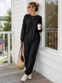 Women's black cable knit two-piece set with long sleeve top and joggers in lifestyle scene - Black