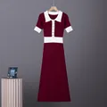 Detailed macro view of wine red knit dress with white polo collar and gold buttons - Burgundy