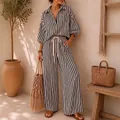 Detailed view of women's black and white striped resort-style shirt and wide-leg trousers. - S / Top And Bottom / Black