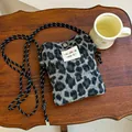 Plush grey leopard print crossbody bag with adjustable cord strap and logo patch - Leopard Print / Gray