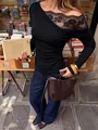 Close-up detail of black French lace spliced one-shoulder long sleeve slim fit top - S / Tops / Black