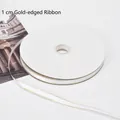 Premium 1cm wide white satin ribbon featuring elegant gold-stitched edges for floral gift wrapping. - 1.0cm * 100 Yards / Porcelain White (Gold Edge)