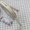 Creamy white ribbed ribbon with black Serendipity cursive print for elegant gift packaging - Serendipity / 1.5cm x 50 Yards / Cream